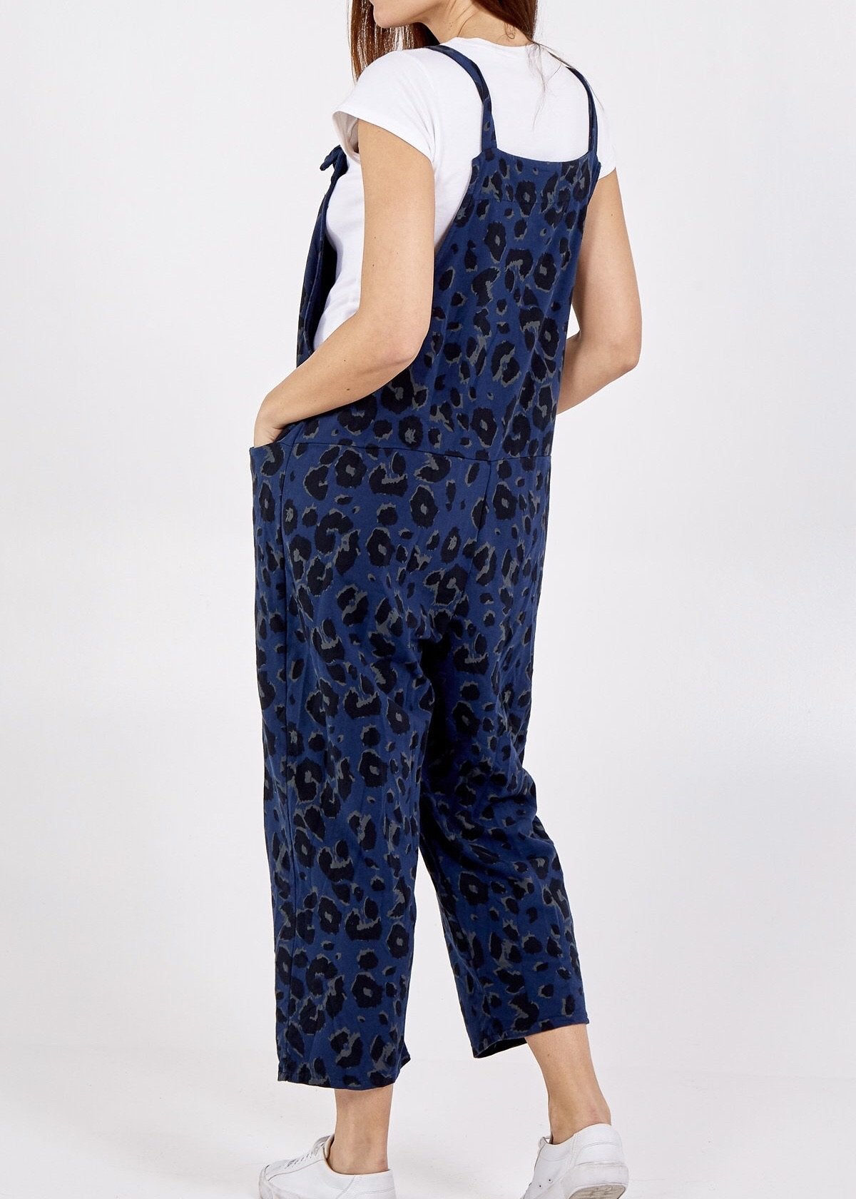 Showing the back of the Porthleven Dungarees in navy with a leopard print pattern 