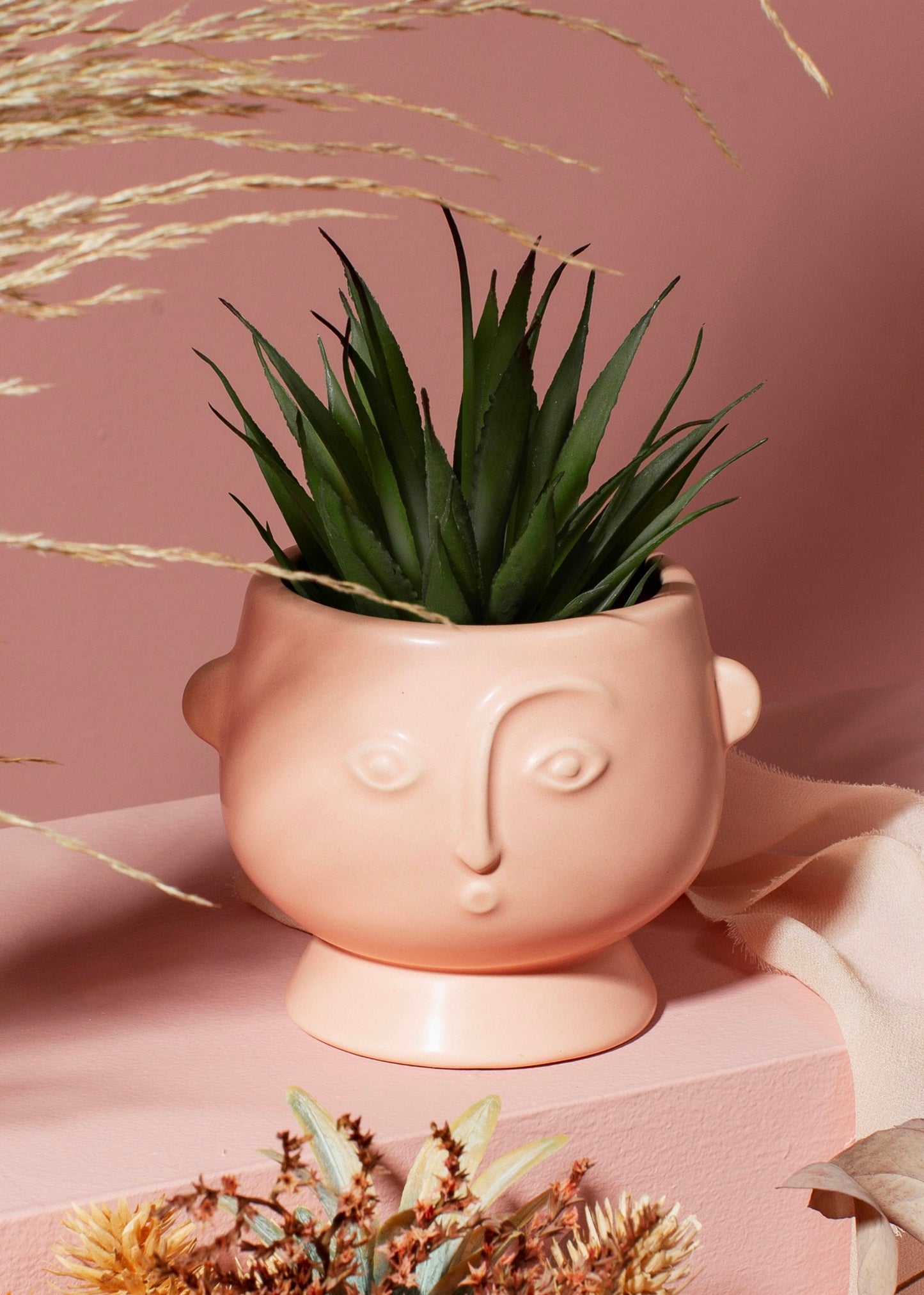matt pink planter with face details 