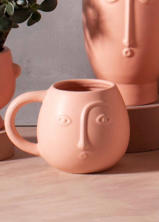 Pink mug with face details 