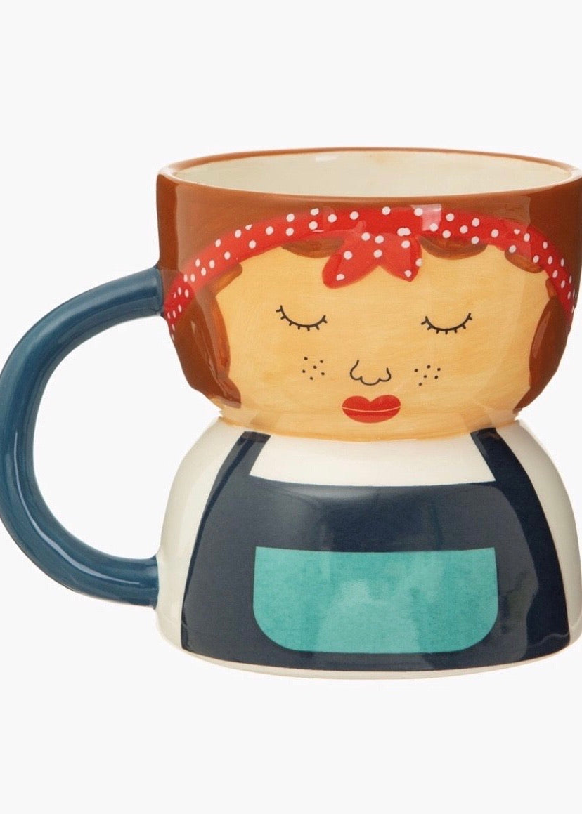 Mug shaped like a lady with blue apron and red head scarf 