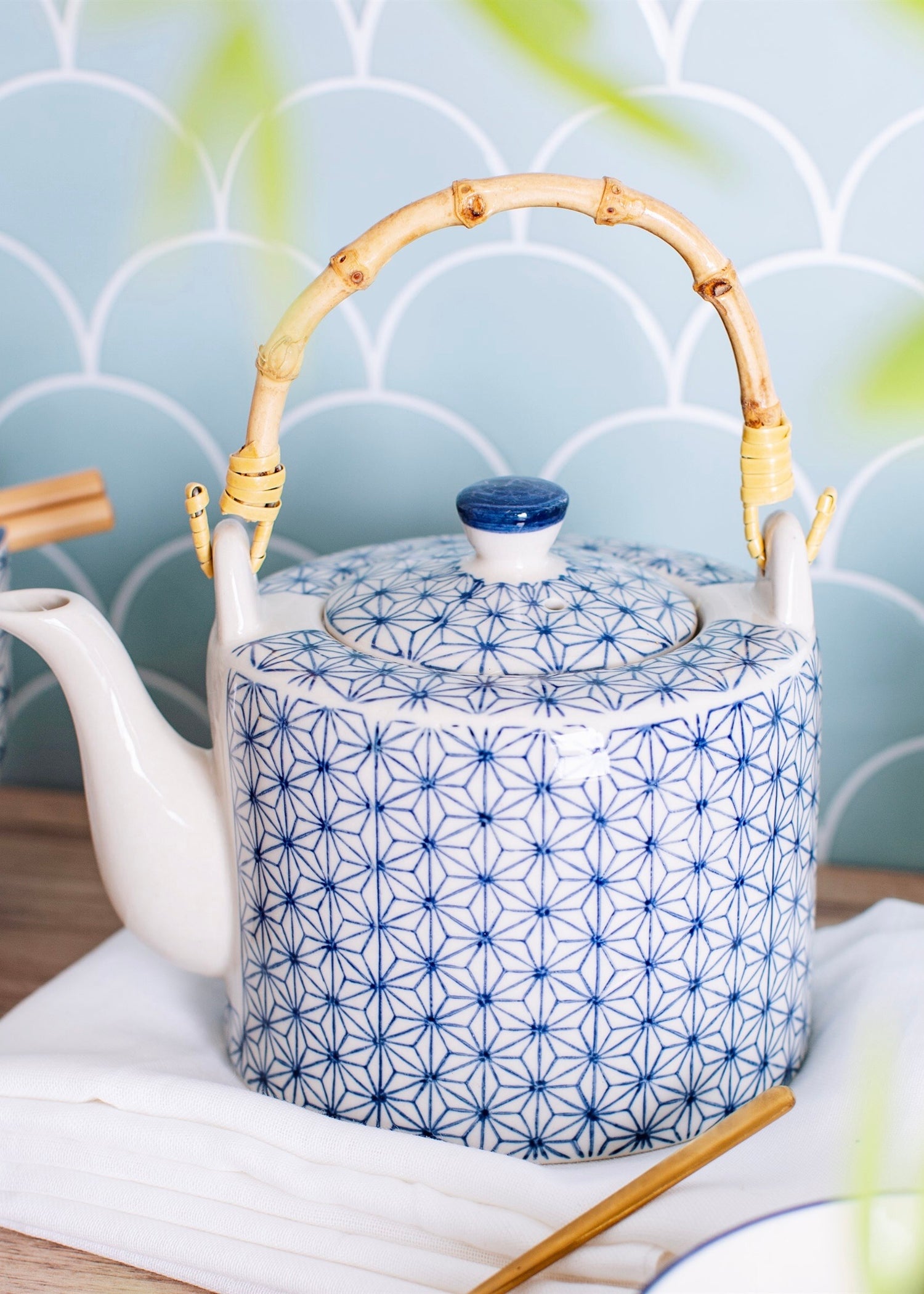 White teapot with blue geometric design with bamboo handle 